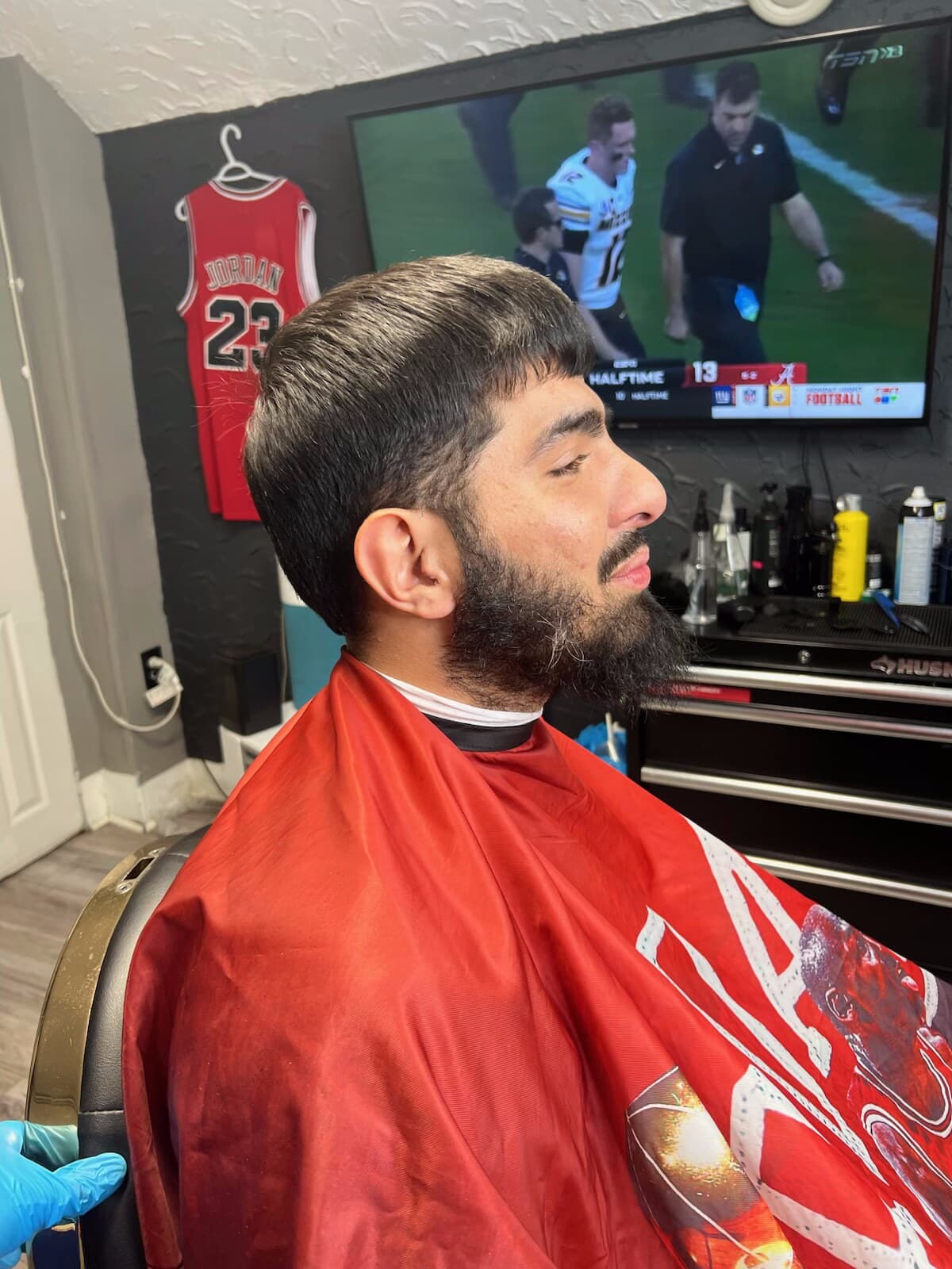 Beard being lined up mid-appointment, side profile in the chair