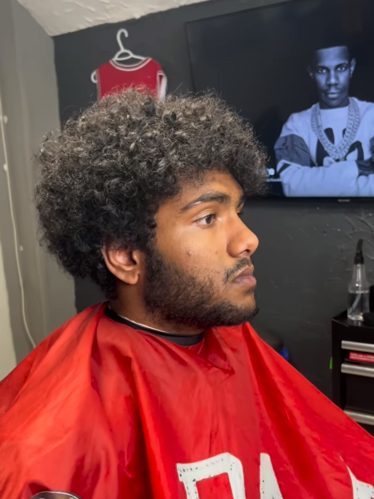 Before: a grown-out curly afro and an unshaped beard